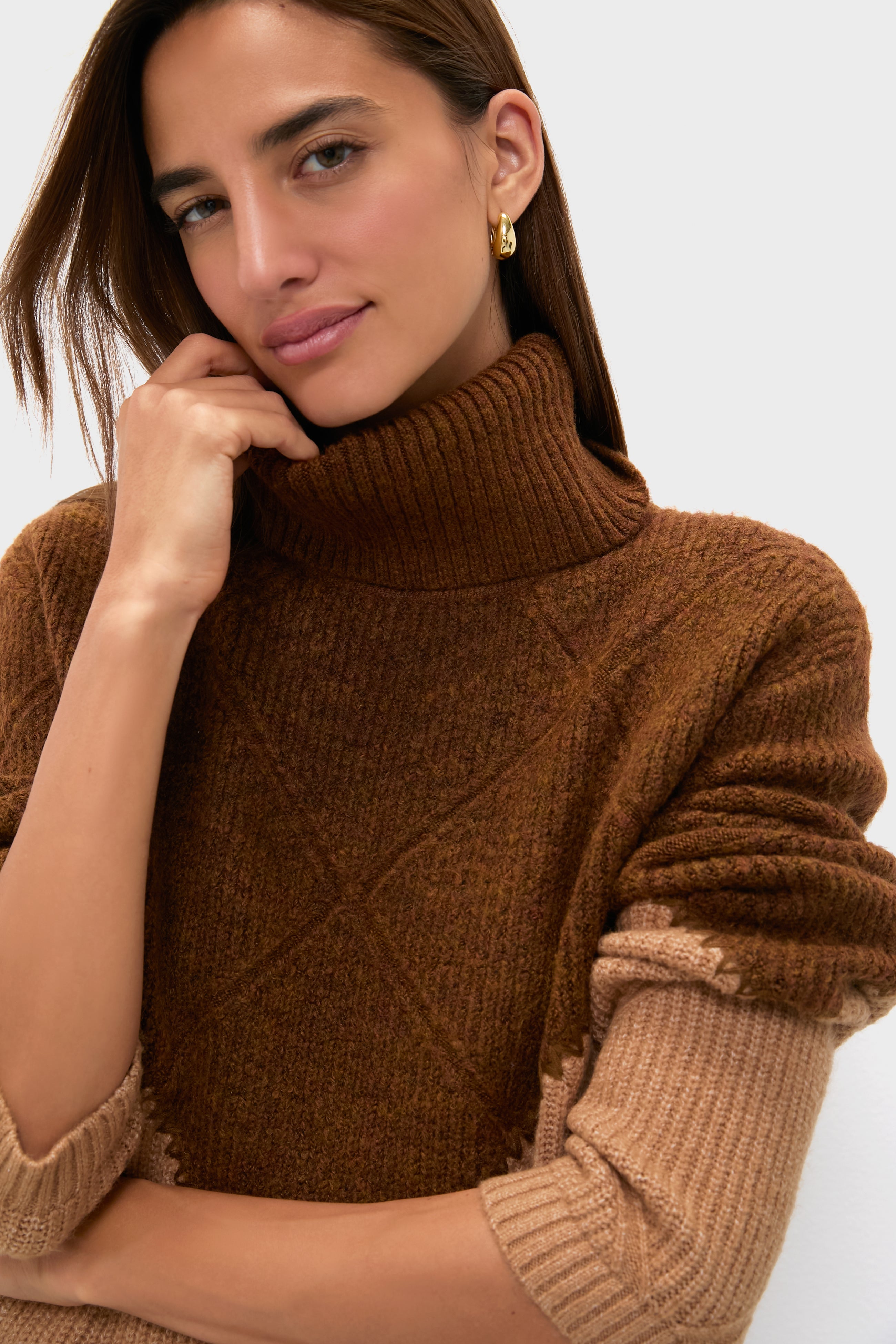 Woman wearing the Tan & Brown Diamond Demi Turtleneck, featuring a classic, effortless color block design with whipstitch detail, embodying high-end, fun style.