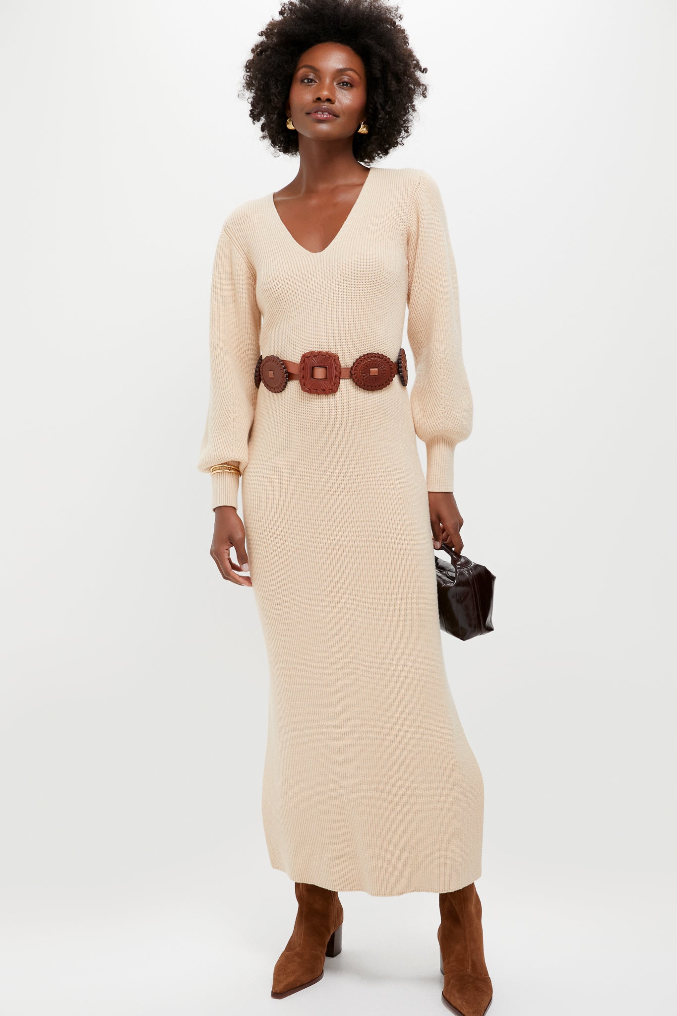 Model wearing classic, high-end Pecan Brown Raffaela Up Mid Boots with pointed toe and block heel, paired effortlessly with a ribbed knit dress and leather accessories.