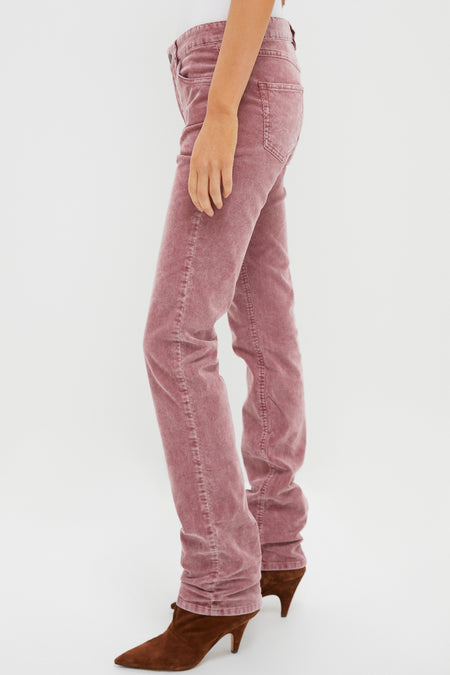 Person wearing light pink Isabel Marant Étoile straight-leg jeans and brown heeled boots, standing against a plain white background.