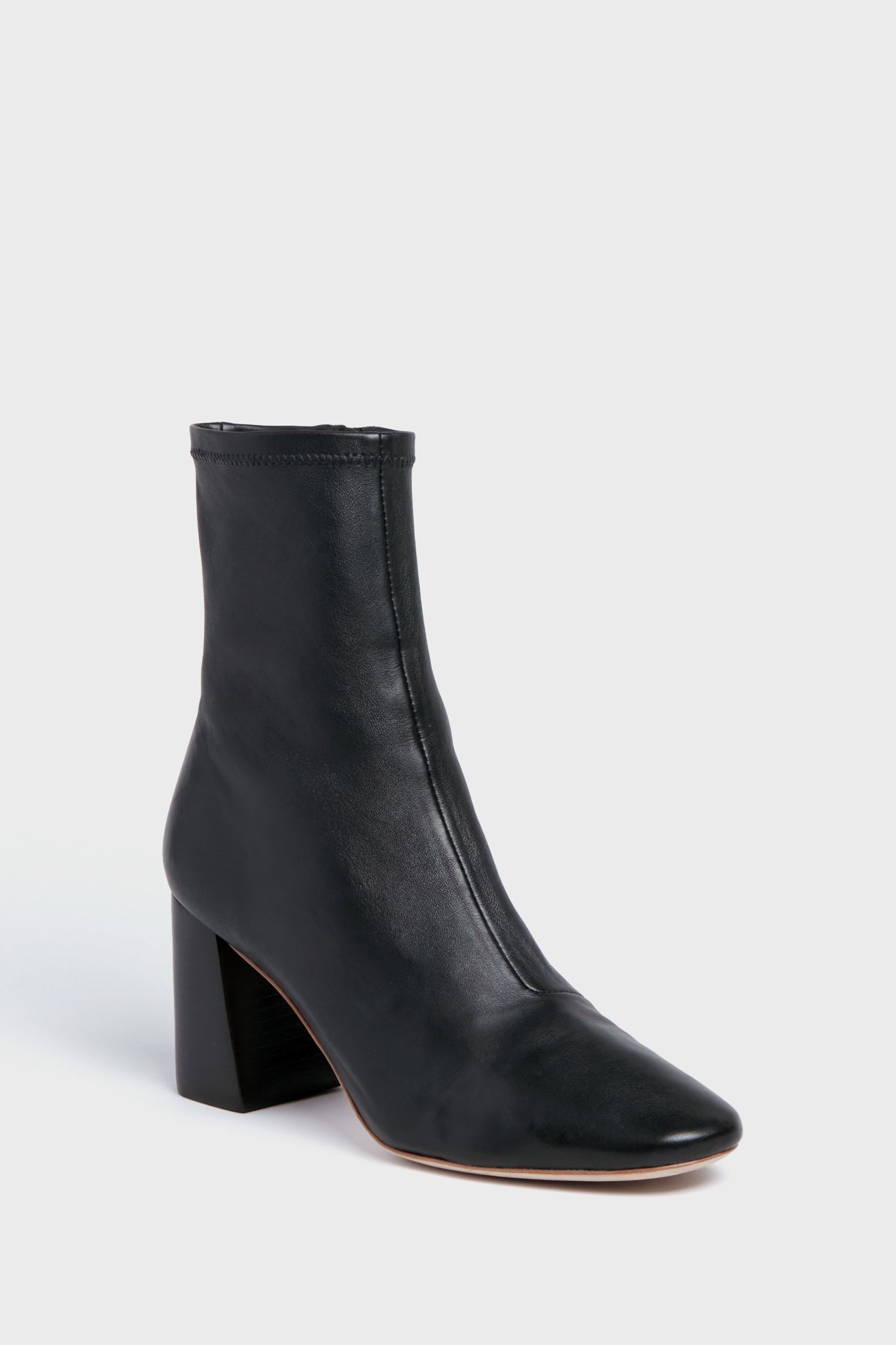Loeffler Randall black ankle boots in Nappa leather feature a block heel, pointed toe, and minimal stitching for a timeless look.