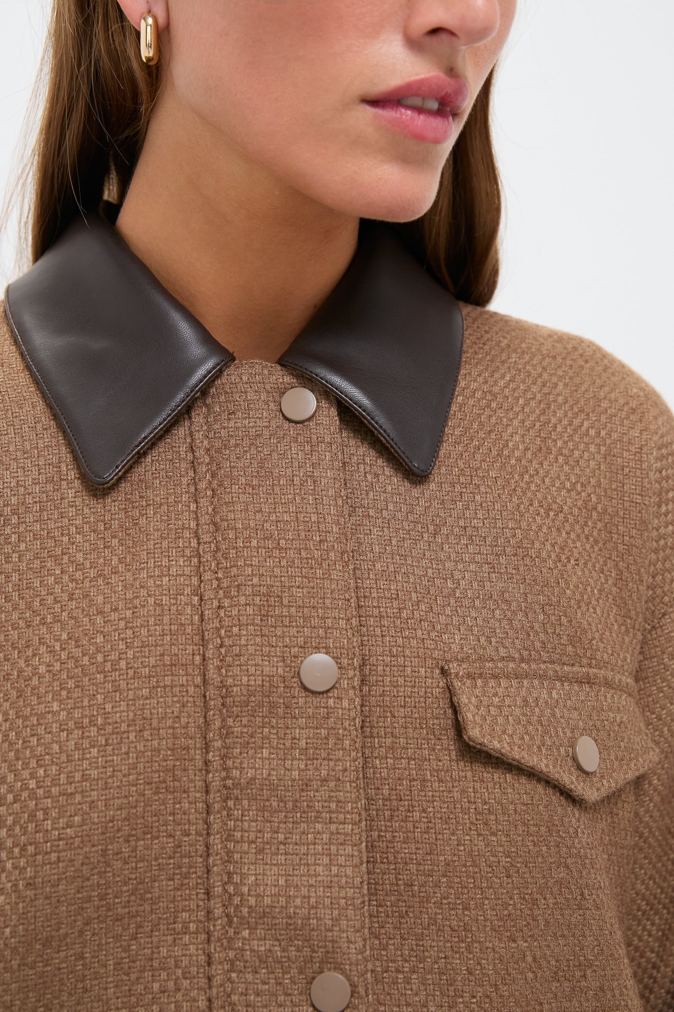 Woman wearing the Brown Bourbon Jacket with a faux leather collar and snap-flap pocket, showcasing its classic, effortless style and high-end textured fabric.