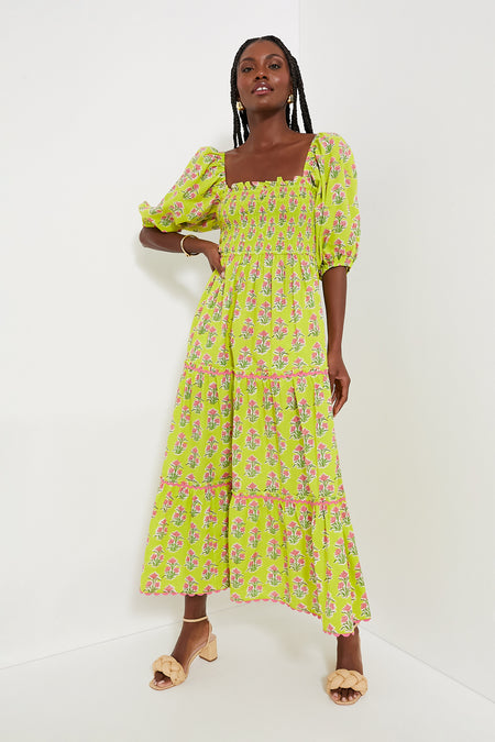 A woman in a bright green floral summer maxi dress with puff sleeves and a square neckline by Pink City Prints, showcasing the charm of organic cotton.