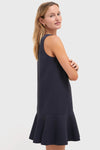 Model in a classic, sleeveless Dark Slate Navy Flutter McKinney Mini Dress, showcasing its effortless swing silhouette and flutter hem for a fun, high-end look.