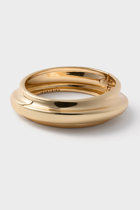 High Polish Gold Lennon Bangle with classic hinge closure, effortless high-end design; stamped JENNYBIRD inside, perfect for a fun, sophisticated wrist stack.
