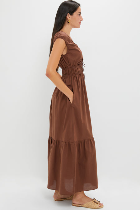 Chestnut Brown Hedda Maxi Dress: A classic, effortless silhouette featuring a tiered skirt, elasticized waist, and drawstring V-neck, paired with chic sandals for a high-end, fun look.