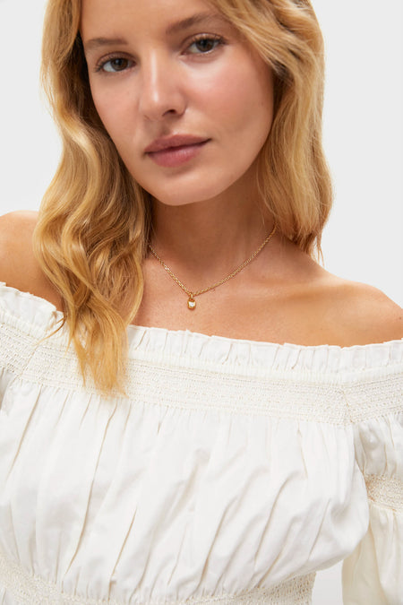 Young woman models the Gold and Crystal Marie Necklace, a classic and effortless piece featuring a delicate gold chain and sparkling pendant, perfect for a fun, high-end look.