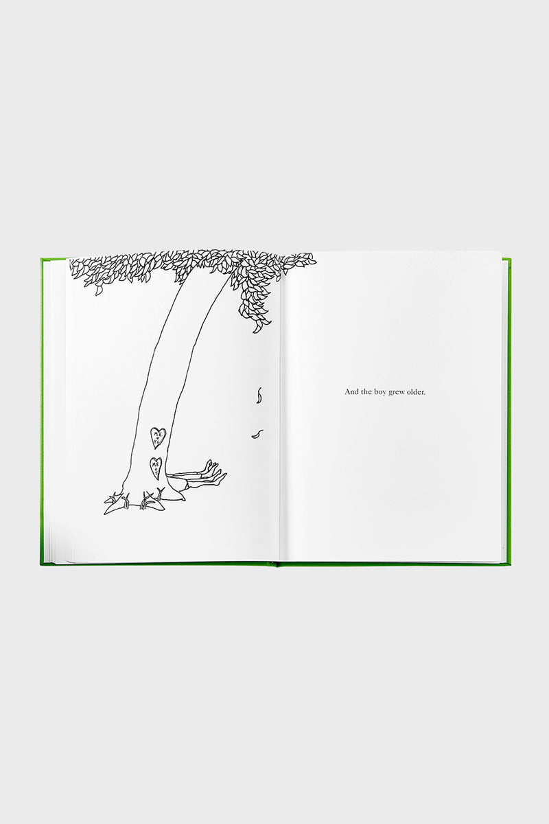 Classic children’s book, The Giving Tree, open to a line drawing of a tree and text, embodying effortless storytelling and high-end design. Fun, timeless reading for all ages.