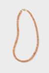 Theodosia circular peach beaded necklace features flat beads and a gold clasp, beautifully handcrafted as fine jewelry.