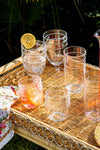 Isabella Acrylic Goblet Set of 4 on a wicker tray, showcasing classic, high-end style for effortless, fun outdoor entertaining with versatile, patterned drinkware.