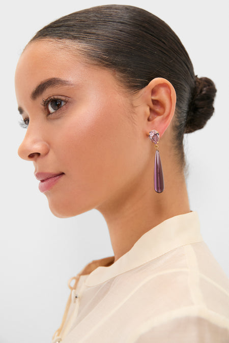 Young woman wearing Amethyst Caroline Earrings featuring a classic, effortless design with a faceted pink stud and smooth purple teardrop pendant, embodying Tuckernuck's high-end, fun style.