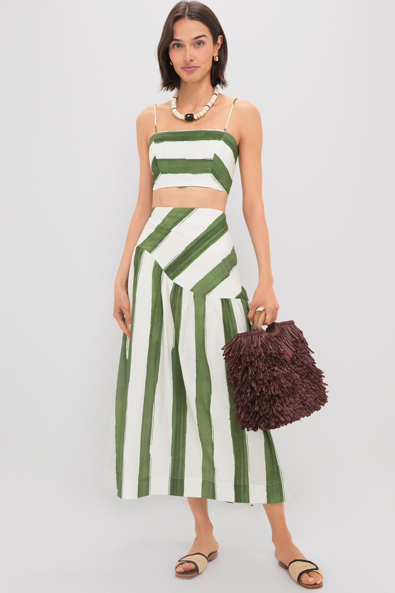 Model wearing Green Stripe Nature Midi Skirt with matching bustier top and fringe handbag, exuding an effortless, high-end style. Perfect for fun, classic summer looks.