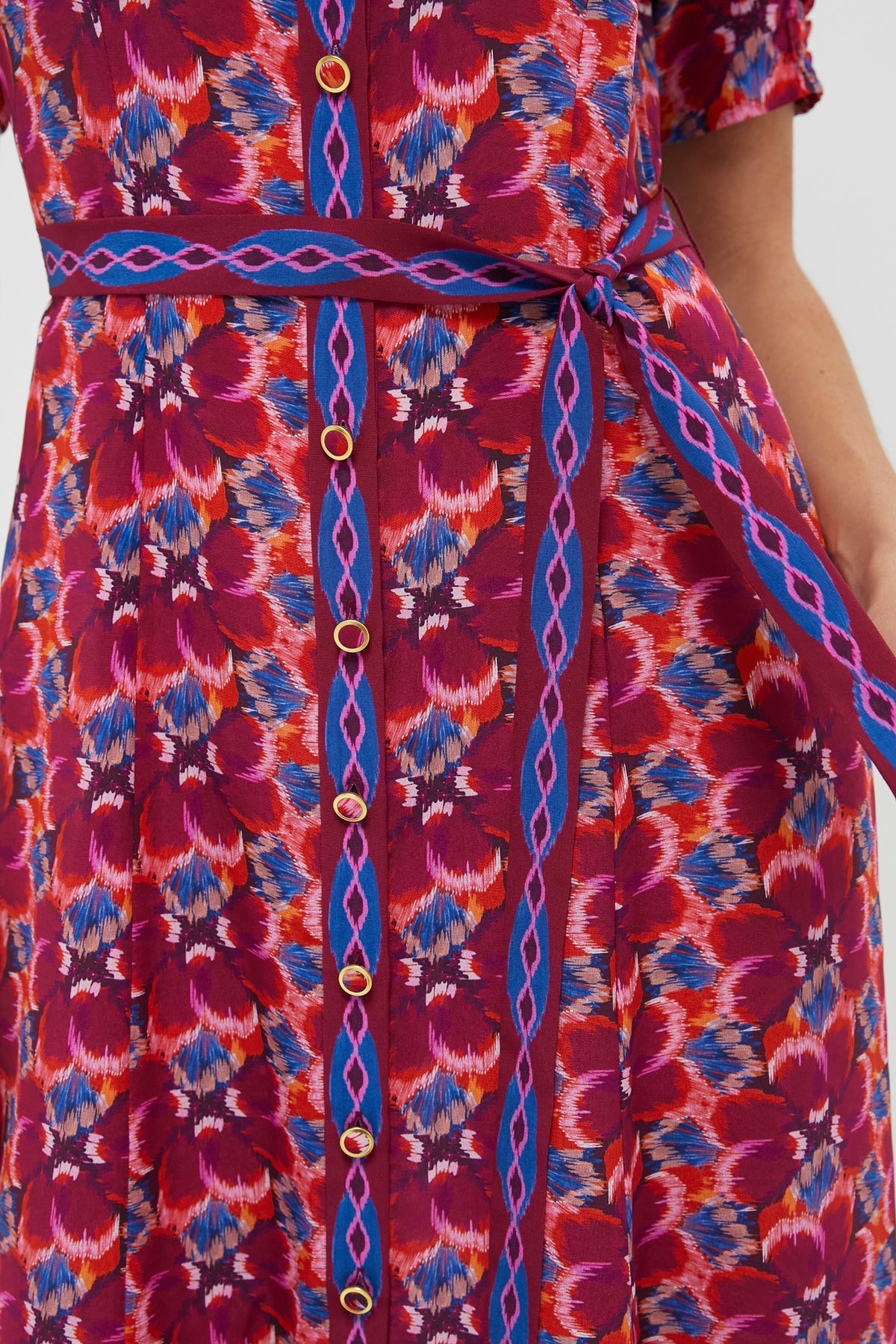 Quail Magenta Vanessa-D Midi Dress with a classic ikat print, effortless A-line silhouette, fun gold-rimmed buttons, and high-end smocked cuffs, showcasing sophisticated style.
