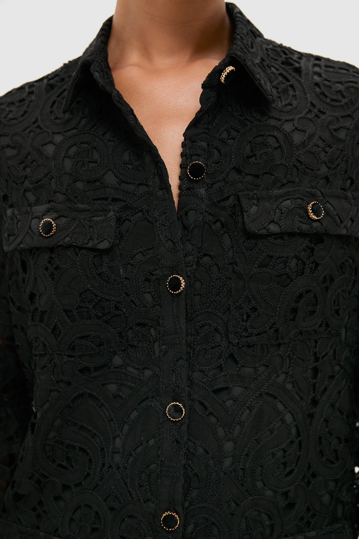 Black Lace Long Sleeve Rachael Mini Dress features intricate lace patterns, gold-edged buttons, and flap pockets, exuding a classic, effortless, and high-end style.