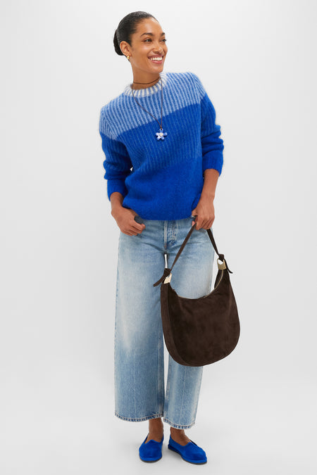 Model wearing the Blue Cocha Sweater in royal blue, paired with cropped jeans and blue loafers, exuding a classic, effortless, and high-end style.