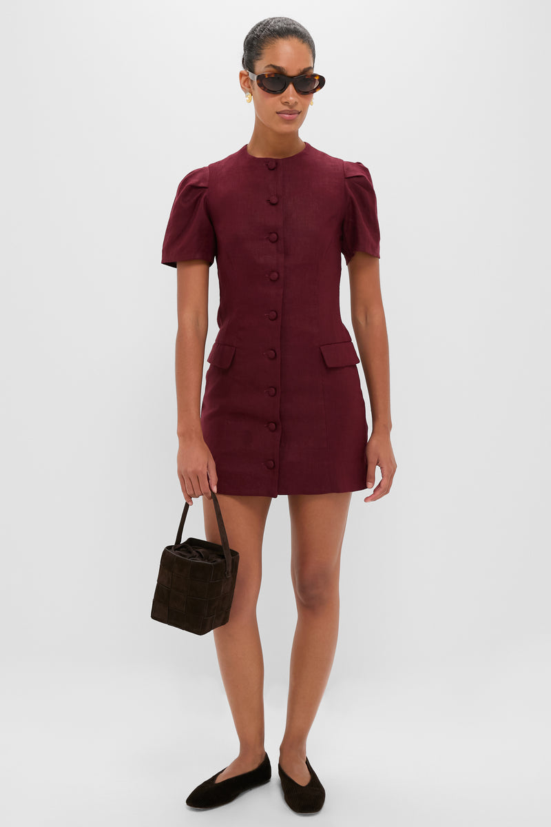 Woman holding the classic Woven Tmoro Suede Laith Top Handle Bag, an effortless high-end accessory with a rich espresso weave and drawstring closure, embodying fun sophistication.