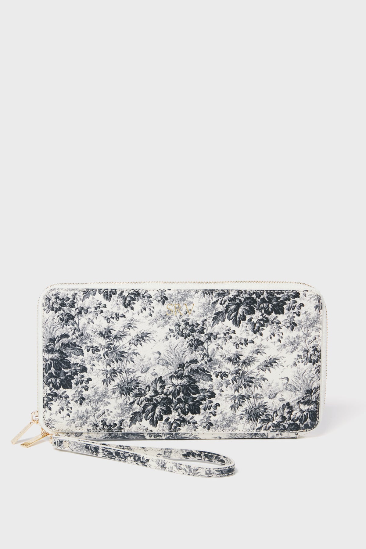 The Tuckernuck Accessories zip-around travel wallet features black and white floral saffiano leather in a rectangular shape, complete with an attached wrist strap.