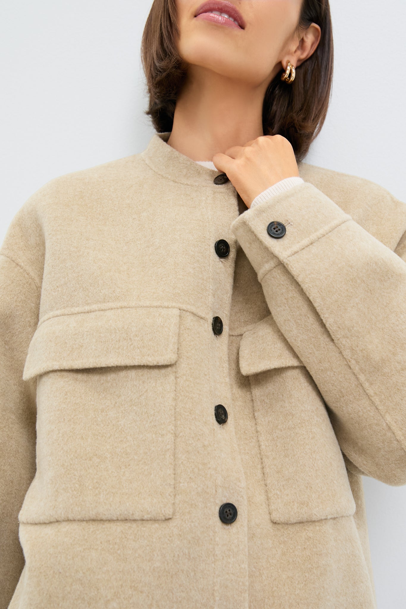 Woman wearing a classic Beige Chine Florian Coat, a wool-textured shacket featuring large chest pockets and dark buttons, embodying an effortless, high-end style.