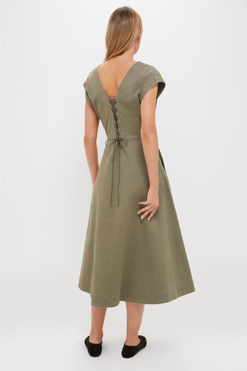 Woman in Burnt Olive Chino Solen Midi Dress showcasing the classic, effortless A-line silhouette with corset lace-up back, embodying a high-end, fun style.