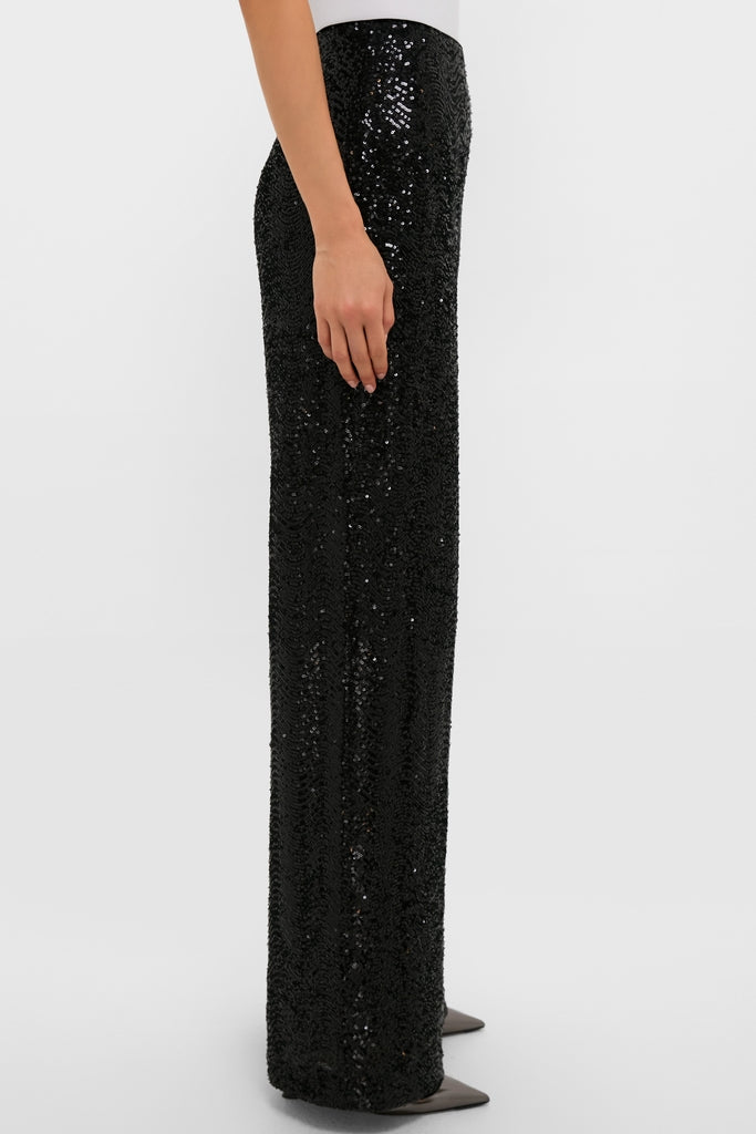 Woman in profile wearing Black Sequin Tatum Pants, showcasing classic, high-end, and effortless style with straight-leg sparkle and fun, paired with pointed-toe heels.