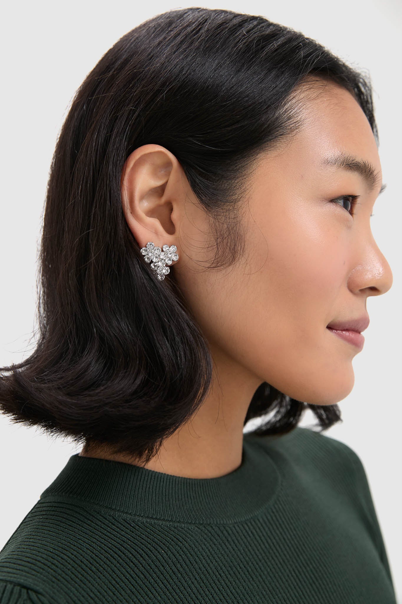 Crystal Violet Stud Earrings elegantly fan along the earlobe, showcasing effortless glam with prong-set crystals for a classic, high-end look, perfect for fun, confident styling.
