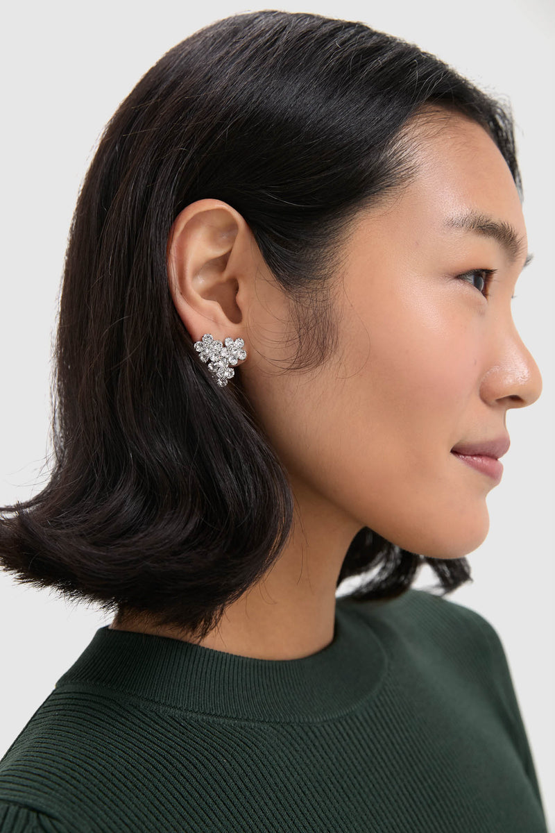 Crystal Violet Stud Earrings elegantly fan along the earlobe, showcasing effortless glam with prong-set crystals for a classic, high-end look, perfect for fun, confident styling.