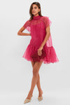 Model in a chic, semi-sheer fuchsia dress holds a matching clutch, showcasing Mixed Crystal Lucy Studs that add effortless, high-end elegance with vintage-inspired multi-color crystals.