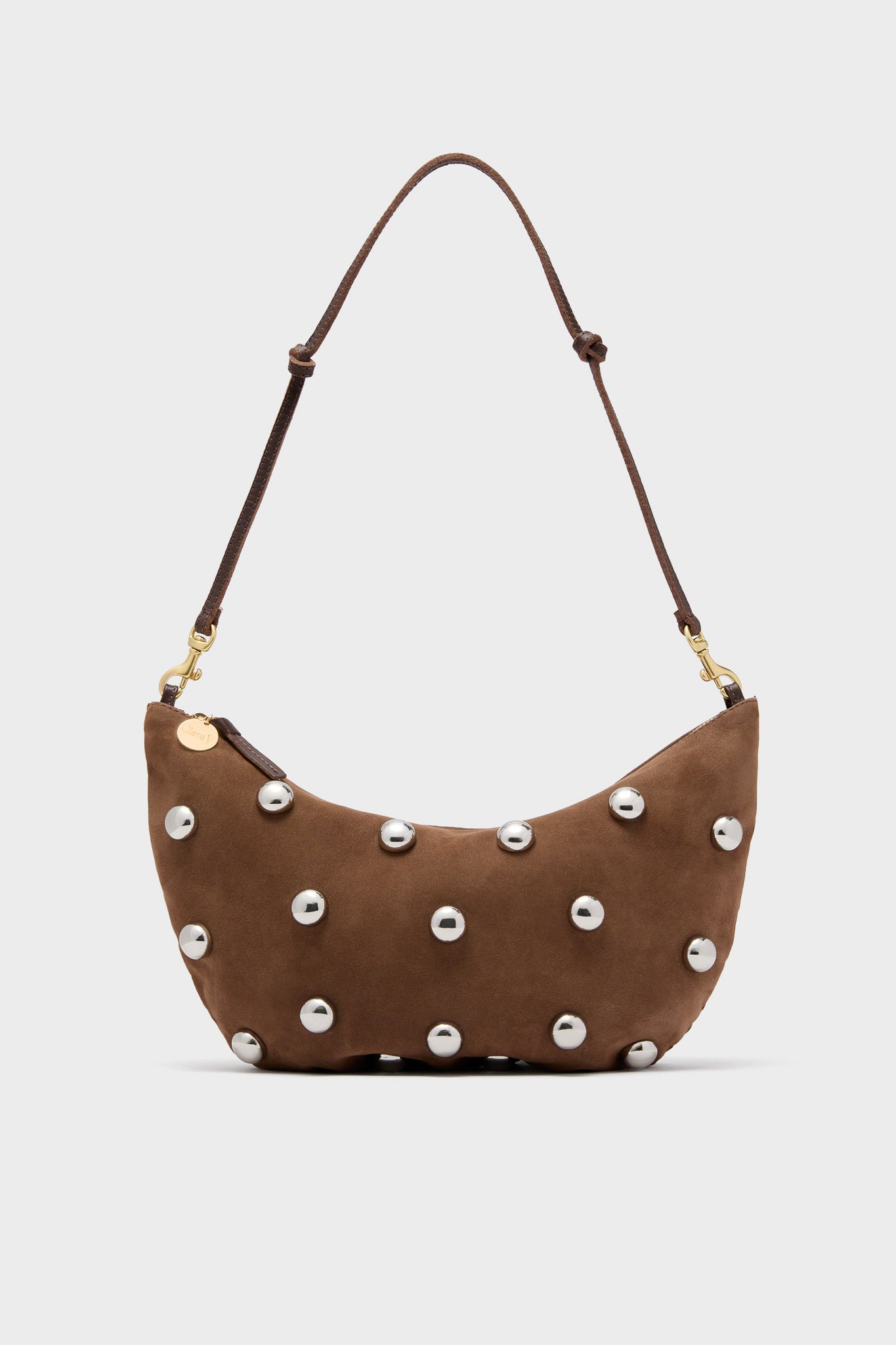 Clare V brown Italian leather shoulder bag with a curved shape, adjustable strap, and front adorned with evenly spaced silver nickel studs.