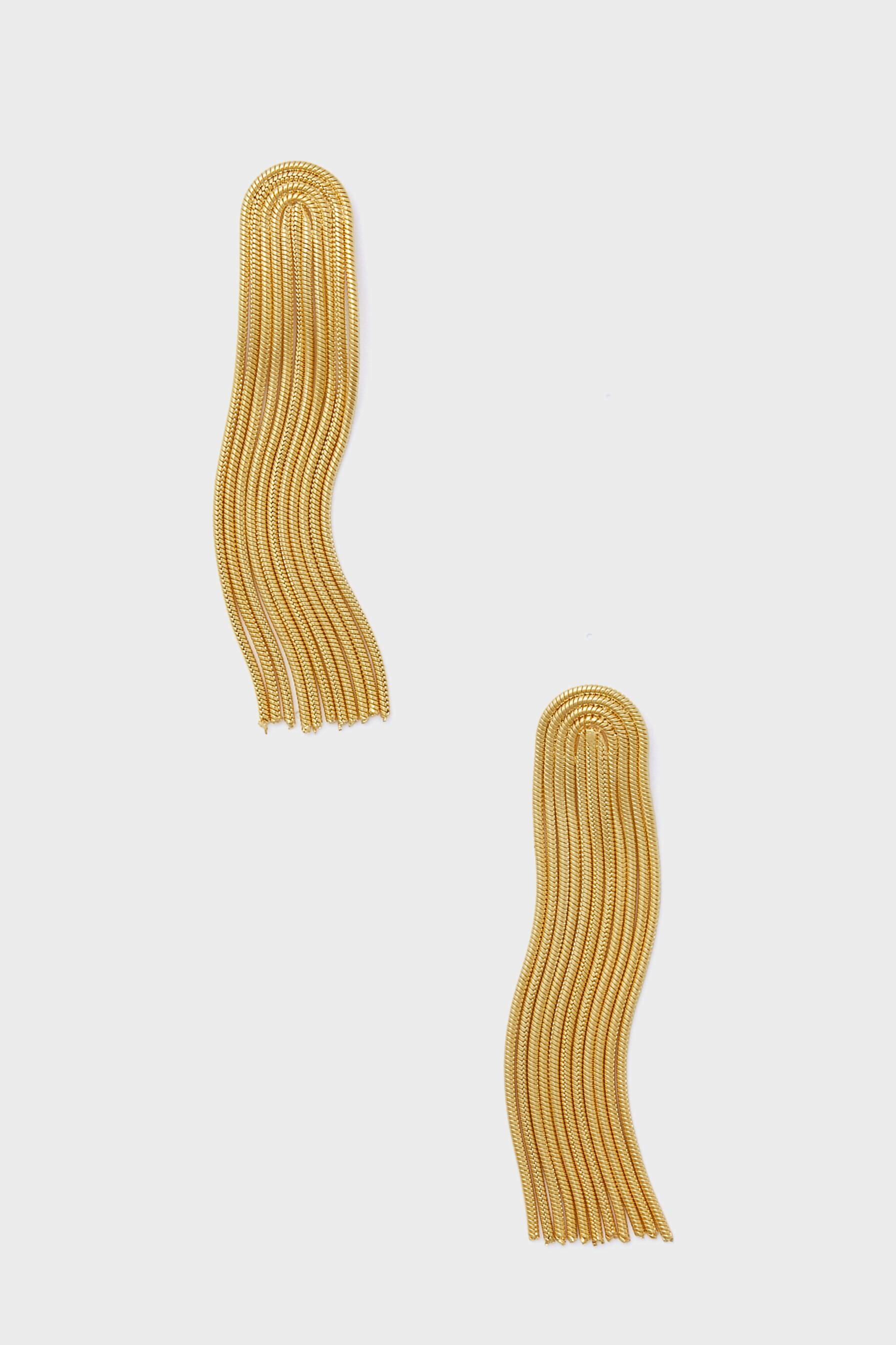 Two gold-tone, curved, multi-strand chain fringe earrings from female-owned brand Petit Moments catch the light with their elegant design.