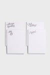 Four white notepads from Dear Annabelle—Always Hustling, Shit List, Quit Stalling, and Noted—add cheeky style to your desk. Perfect for stationery fans, each features a cursive heading on a simple gray background.