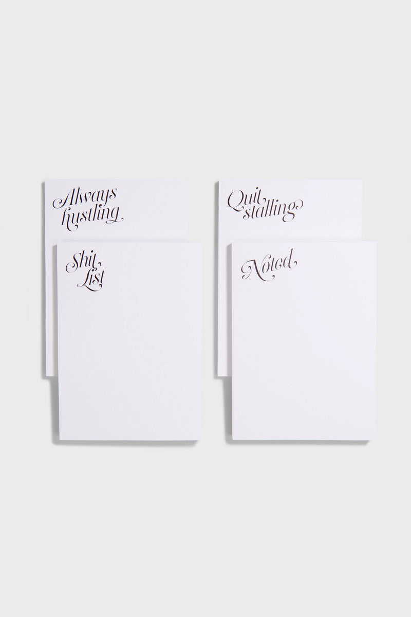 Four white notepads from Dear Annabelle—Always Hustling, Shit List, Quit Stalling, and Noted—add cheeky style to your desk. Perfect for stationery fans, each features a cursive heading on a simple gray background.