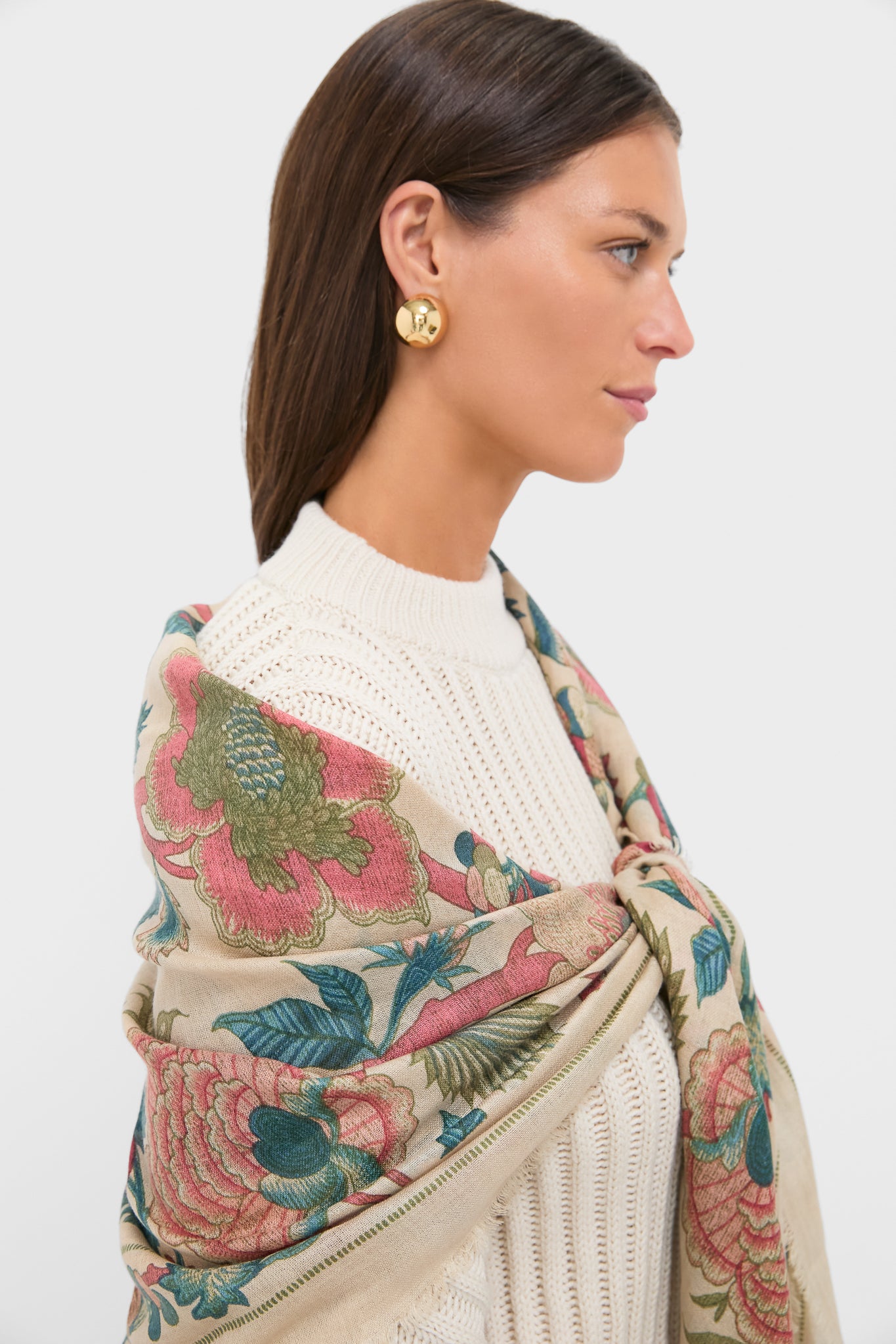 Side-profile of a woman wearing a Garden Scrollwork Silk Cashmere Blend Large Scarf, effortlessly draped over a chunky knit sweater, showcasing a classic, high-end look.