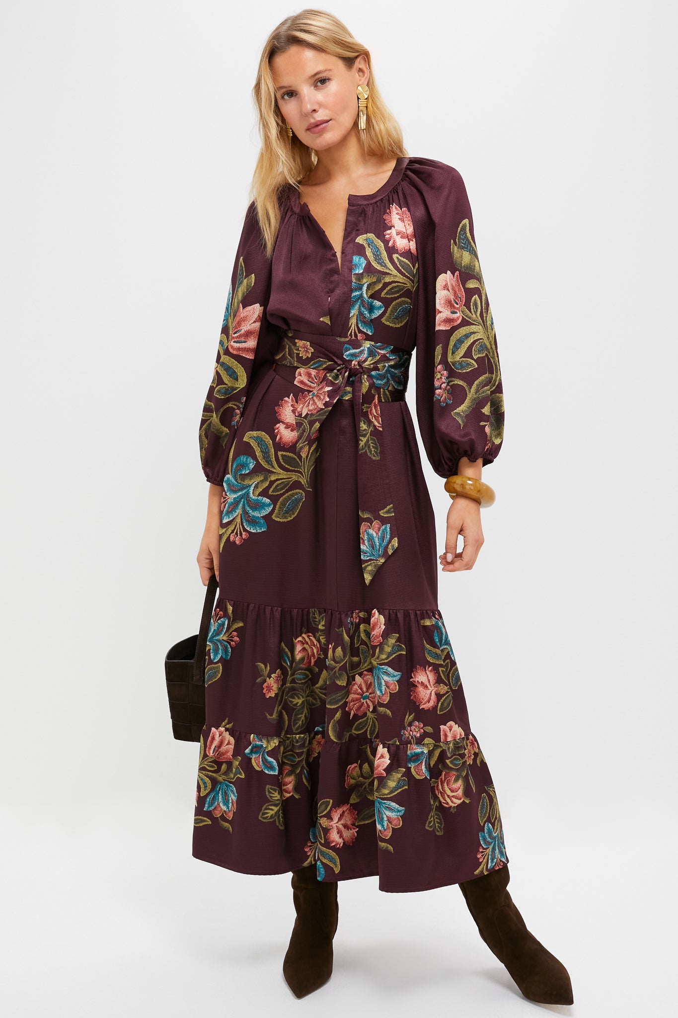 Model showcases classic Gold Fringe Louisa Earrings, effortlessly paired with a tiered maxi dress, adding high-end flair and fun to this chic ensemble.