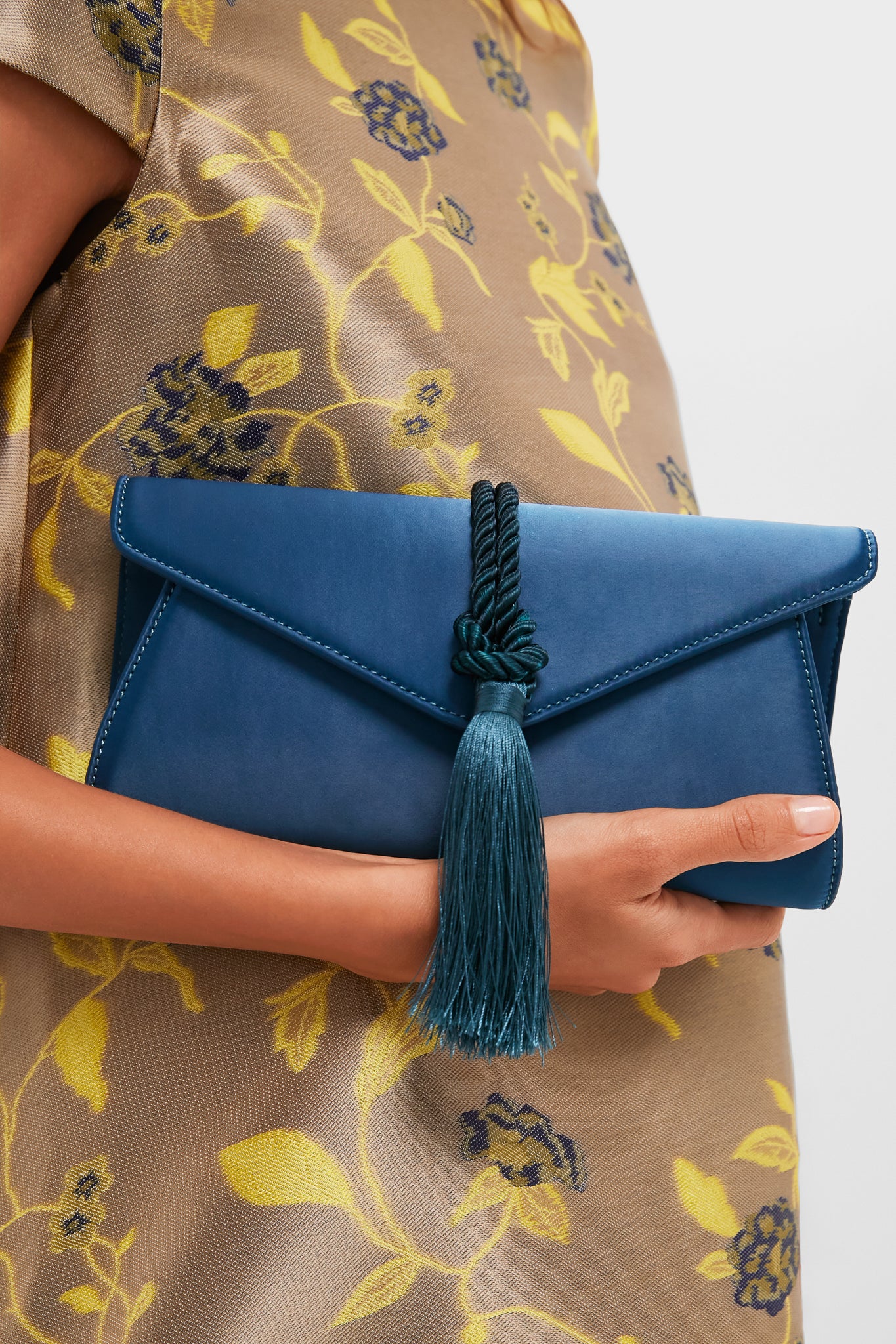 Peacock Blue Satin Gabrielle Clutch with a classic envelope design, featuring a braided tassel and magnetic closure. Effortless and high-end, perfect for fun, elegant occasions.