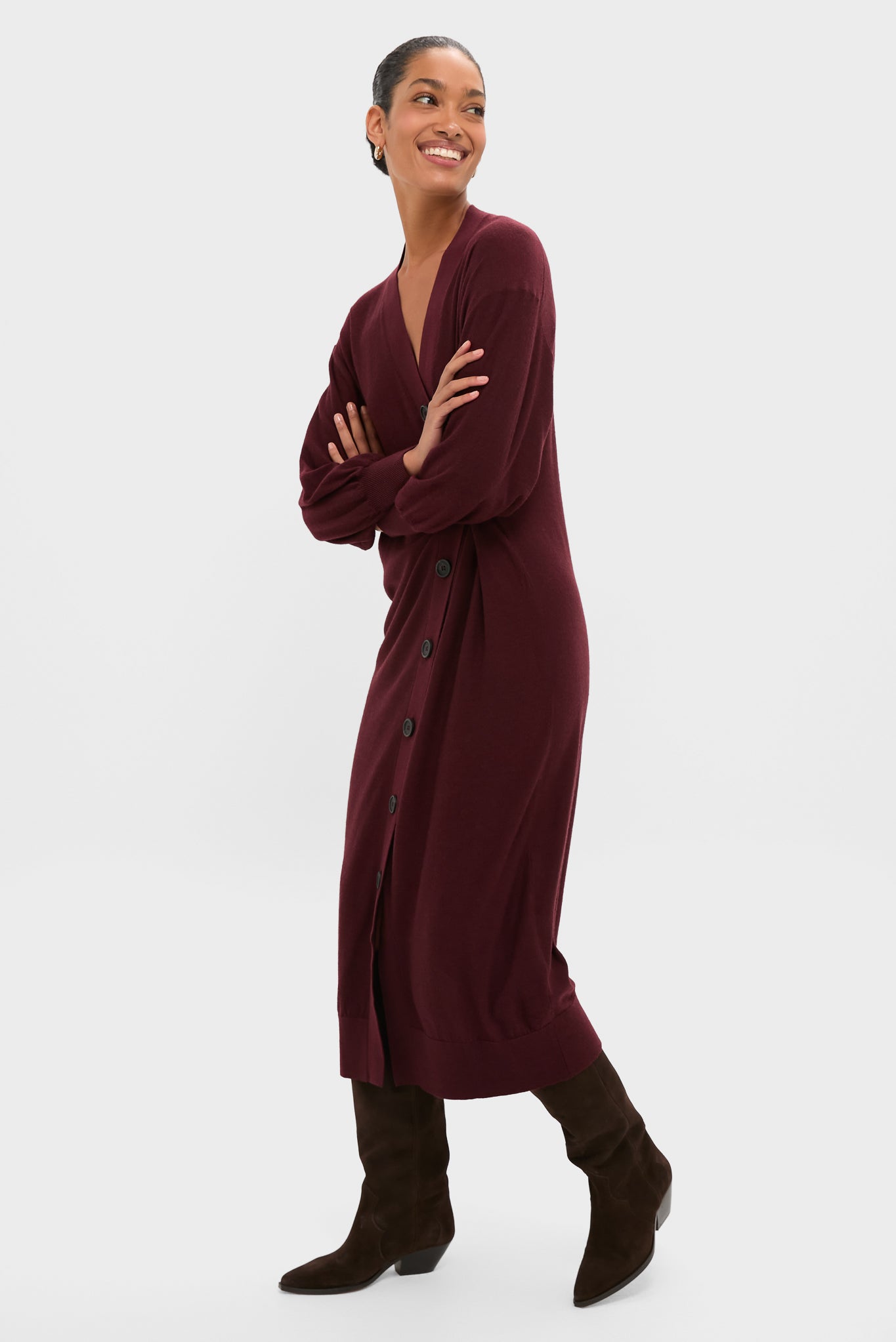 Model wearing the classic Mulberry Drippy Cardi Dress, effortlessly styled with knee-high boots, showcasing its fun, asymmetrical design and high-end, relaxed fit.