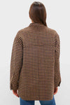 Back view of a woman in a classic Noir and Noisette Florian Coat, showcasing its effortless, oversized houndstooth design, perfect for a fun and high-end layered look.