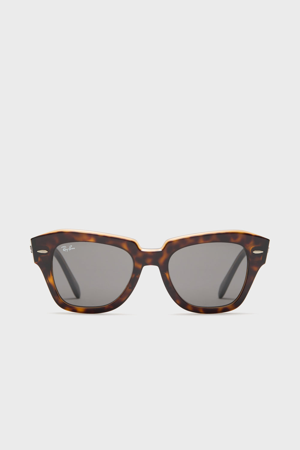 Ray-Ban tortoise shell sunglasses featuring a rectangular frame and dark lenses, inspired by the classic Wayfarer design.