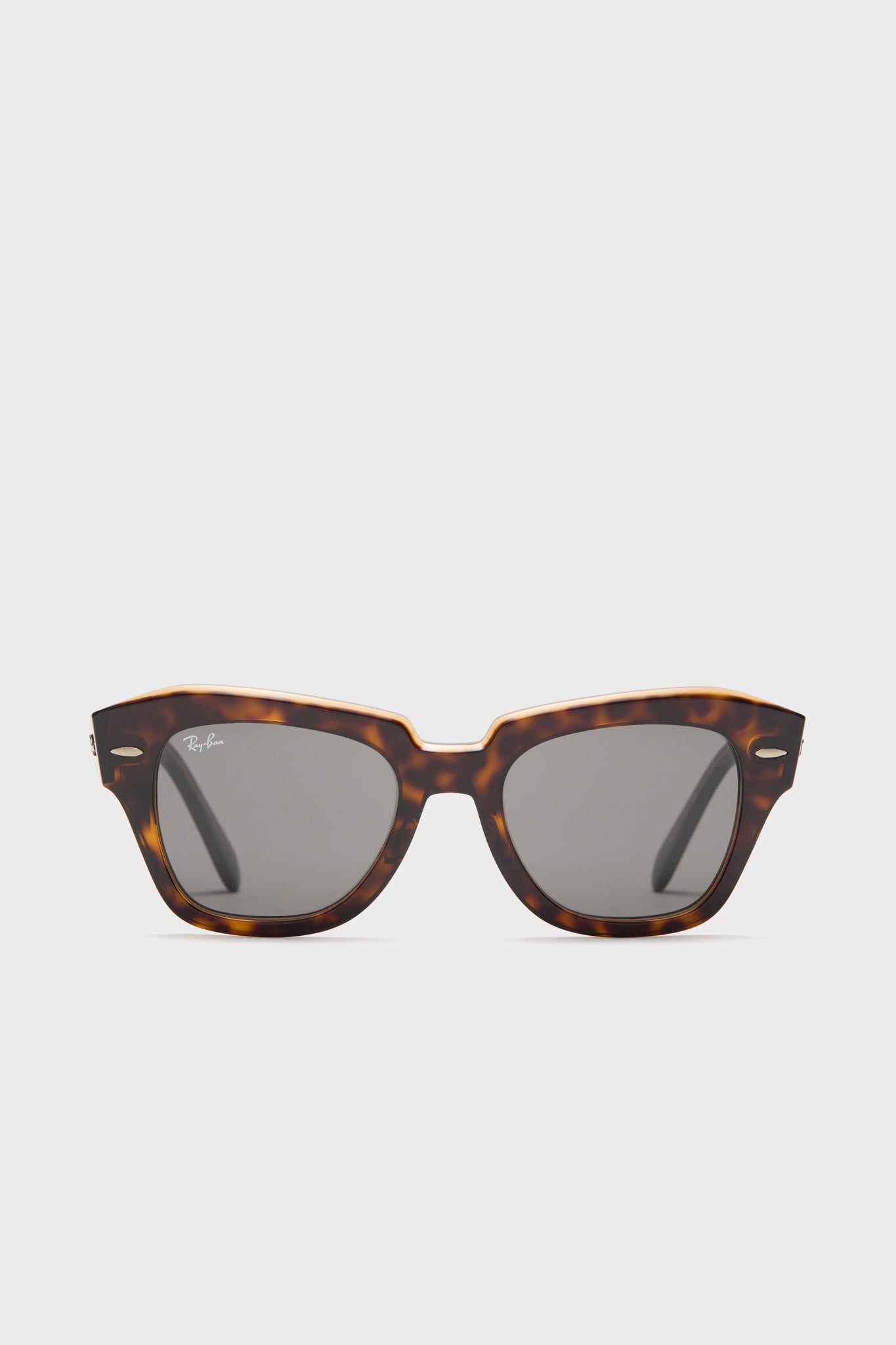 Ray-Ban tortoise shell sunglasses featuring a rectangular frame and dark lenses, inspired by the classic Wayfarer design.