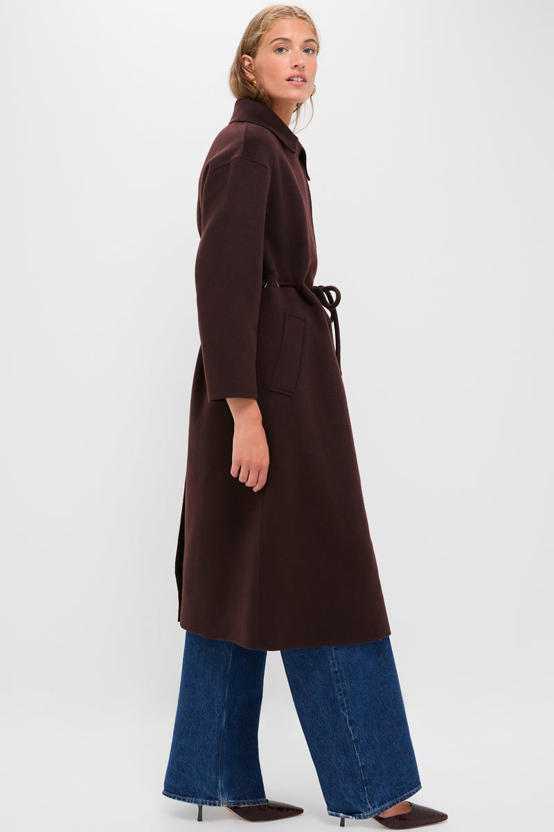 Model in profile wears the classic Chocolate Kate Coat, showcasing an effortless, high-end style. The coat features a wide V-collar and drawstring waist, embodying Tuckernuck's fun elegance.