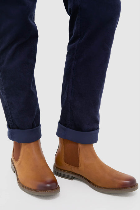 Dark Tan Farsley Chelsea Boots paired with cuffed trousers, showcasing classic, high-end style with effortless elastic side panels and fun Barbour branded pull loops.