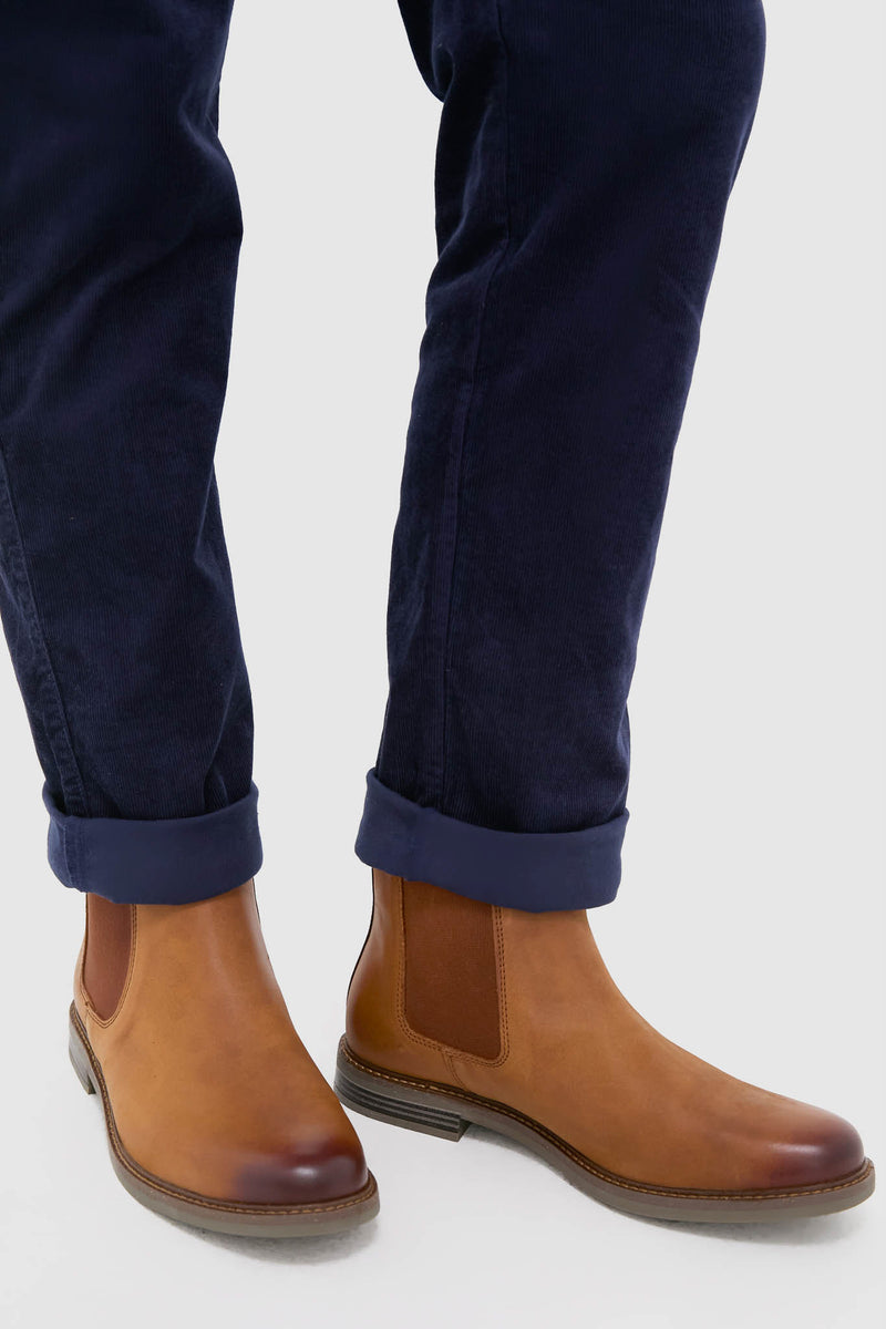 Dark Tan Farsley Chelsea Boots paired with cuffed trousers, showcasing classic, high-end style with effortless elastic side panels and fun Barbour branded pull loops.