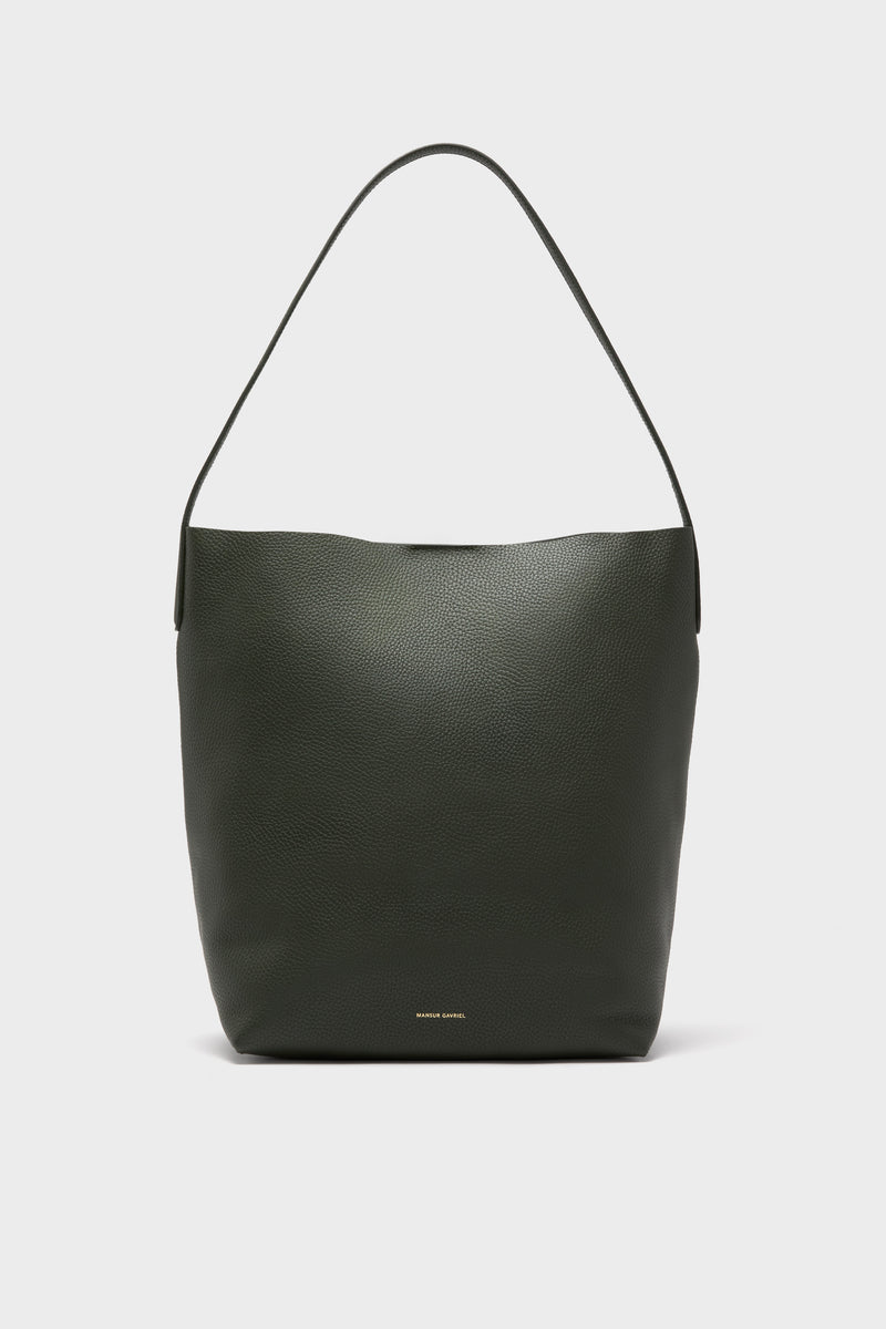 The Mansur Gavriel structured tote is crafted from dark green Italian leather with a single shoulder strap, minimal design, and subtle gold branding near the bottom center.