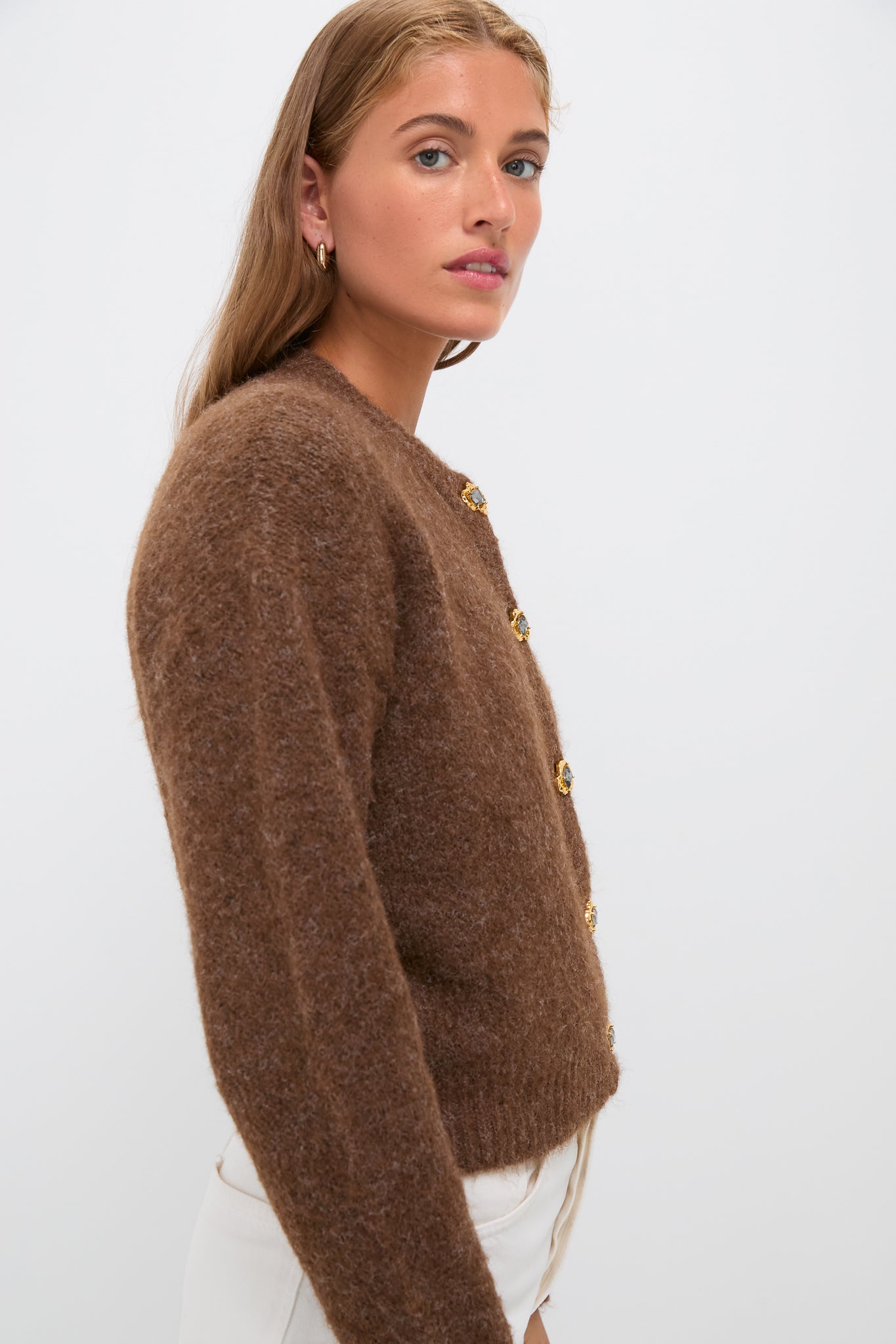 Young woman models the Brown Morgan Cardigan, a classic, high-end knit with gold-tone crystal buttons, embodying an effortless, fun style.