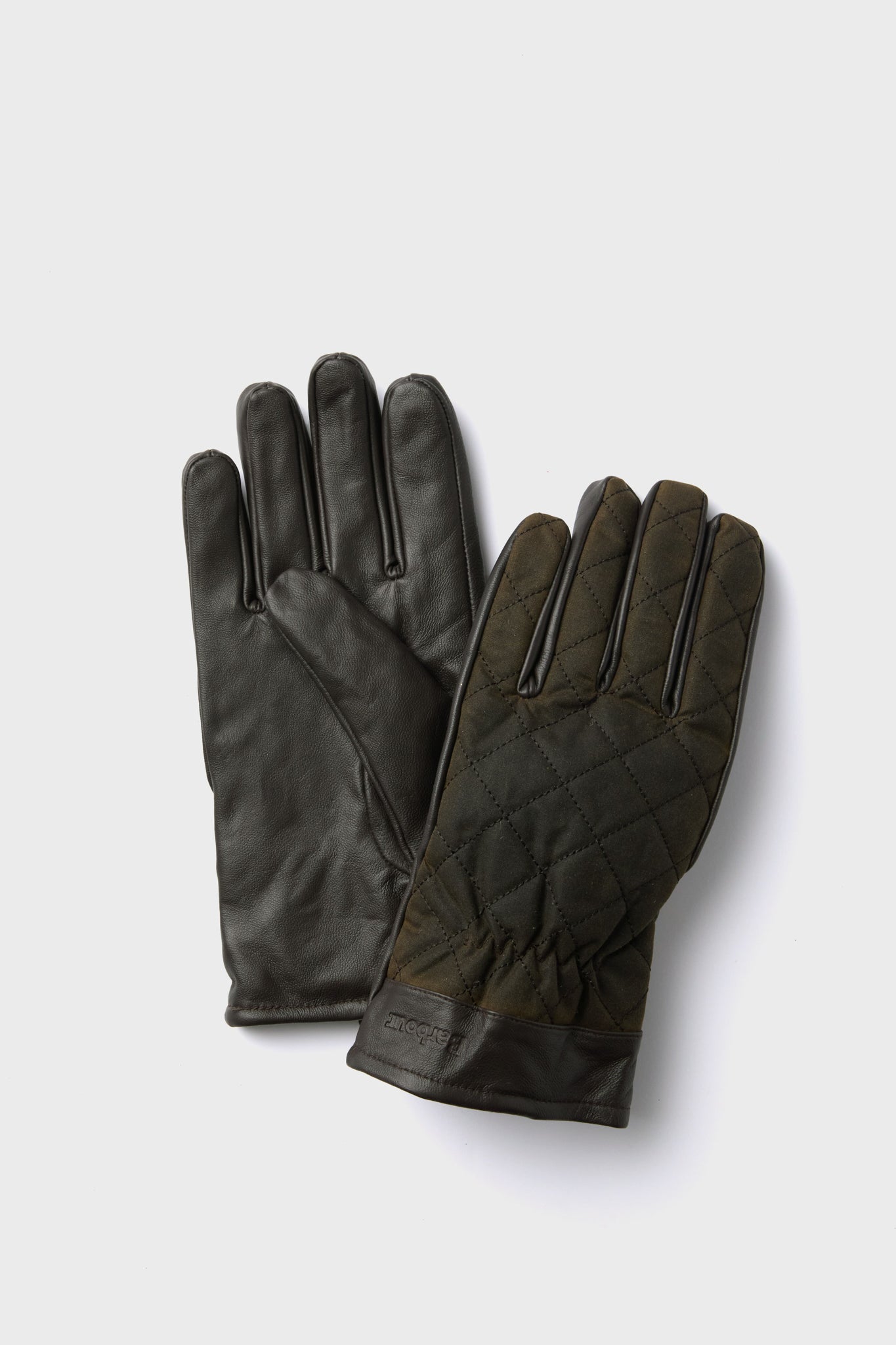 A pair of dark green Barbour gloves made from quilted waxed cotton with nappa leather palms and cuffs.
