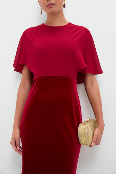 Cranberry Velvet Chiffon Mixed Media Cape Leah Dress exudes classic elegance, featuring an effortless cape overlay and a fun, high-end velvet skirt, paired with a structured gold clutch.