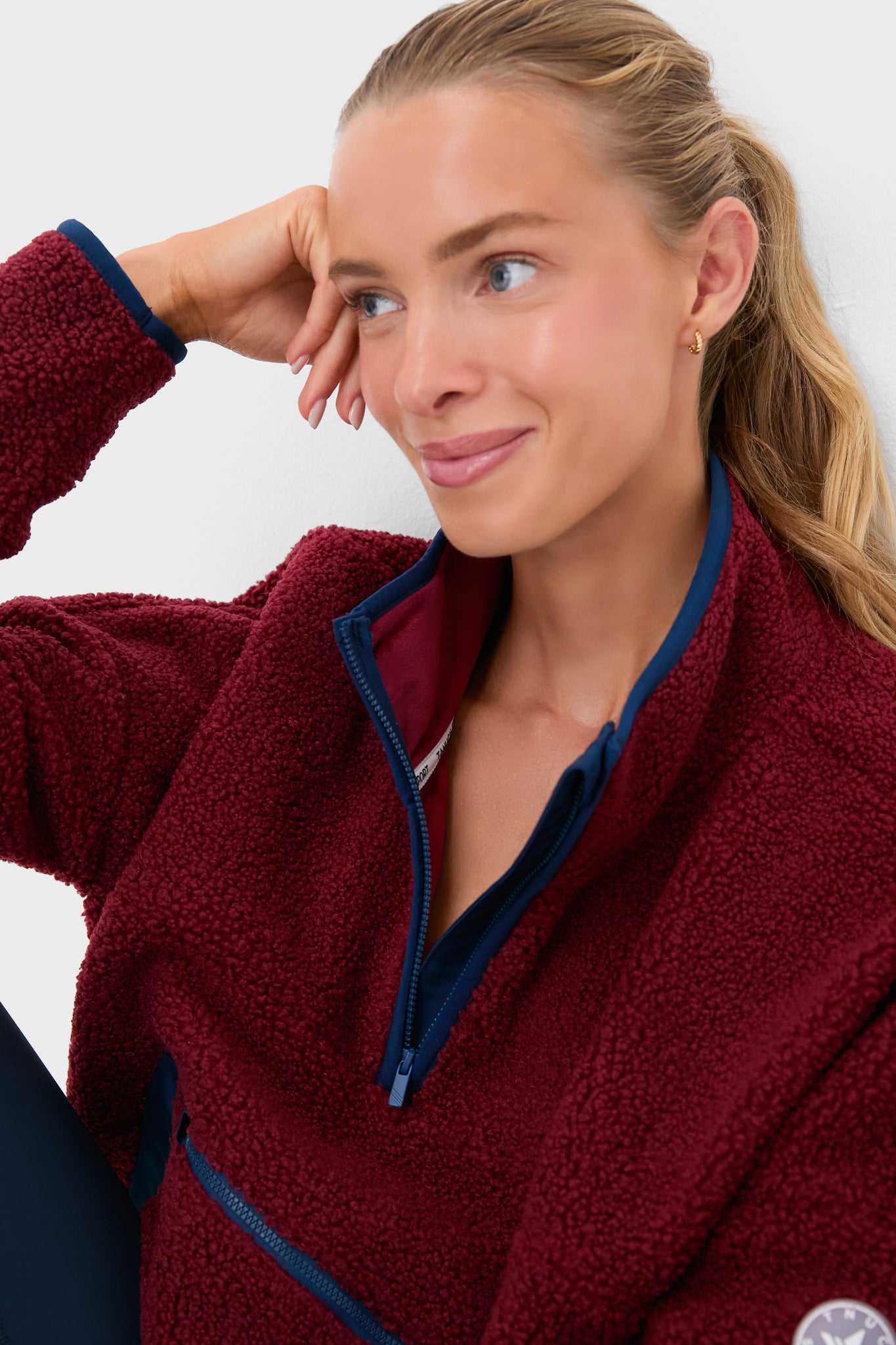Cabernet Fleece Cady Quarter Zip exudes classic, effortless style with its cozy sherpa texture, navy trim, and functional pockets, perfect for versatile, high-end layering.