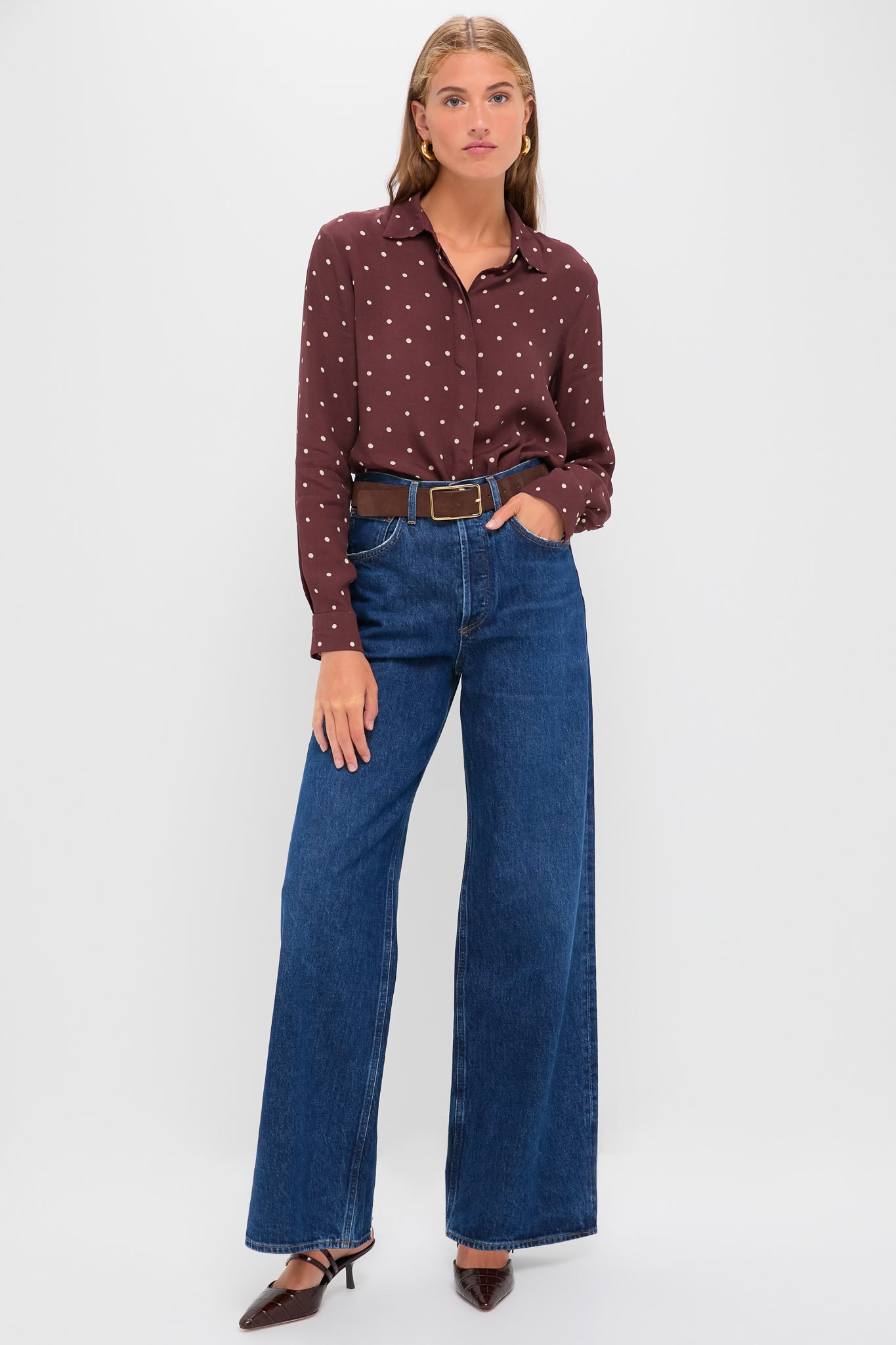 Young woman in Night Print Crepe Shirt showcasing classic sophistication with its playful polka dots, paired with effortless high-waisted jeans and fun, high-end accessories.