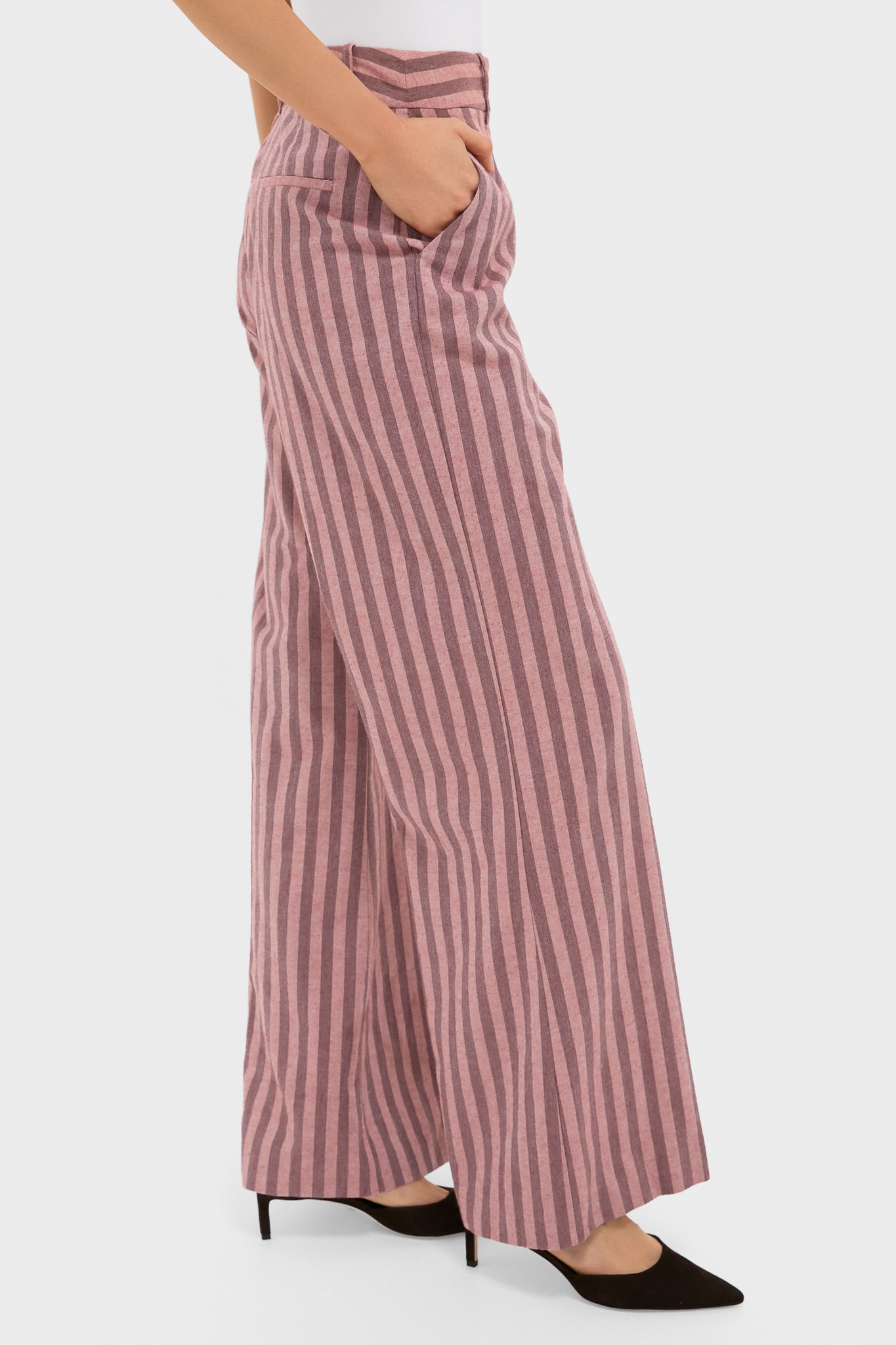 Mauve Stripe Wyatt Pants showcase a classic wide-leg, high-waisted design with vertical pink stripes and side pockets, paired with black mid-heel shoes for effortless style.