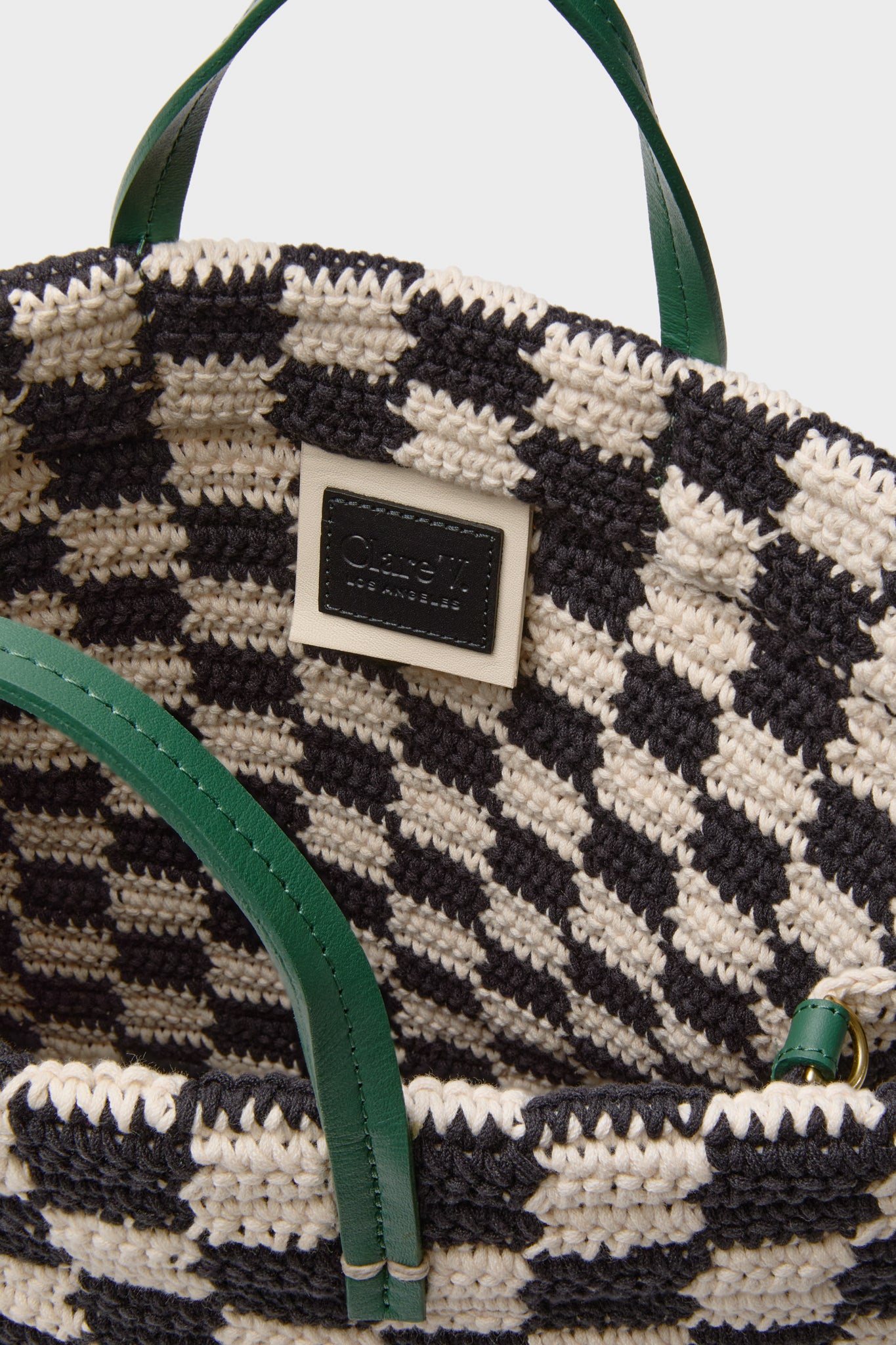 Black and Cream Crochet Checker Summer Simple Tote with a classic, effortless design, featuring green leather handles, a Clare V. patch, and a fun, high-end vibe.