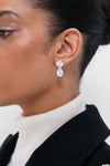 Classic elegance meets effortless style with the Crystal Pamina Earrings, featuring a clear teardrop crystal and a round stud, perfect for high-end, fun occasions.