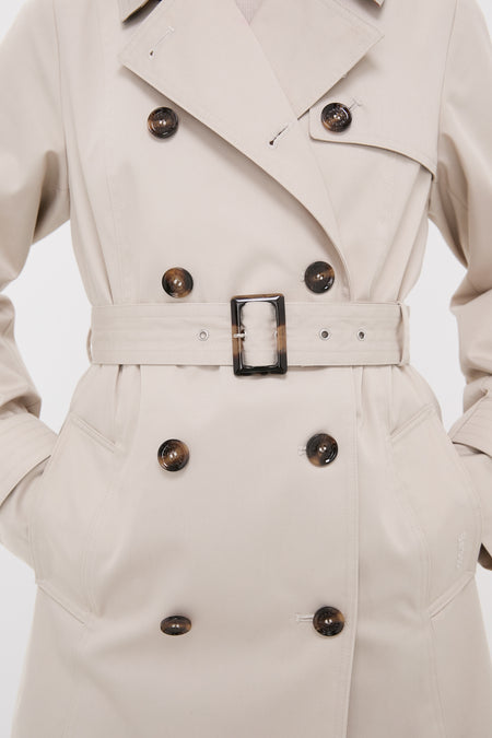 Mist Short Greta Showerproof Jacket, a classic, high-end trench coat with tortoiseshell buttons, wide lapel, and belt, embodying effortless style and fun versatility.